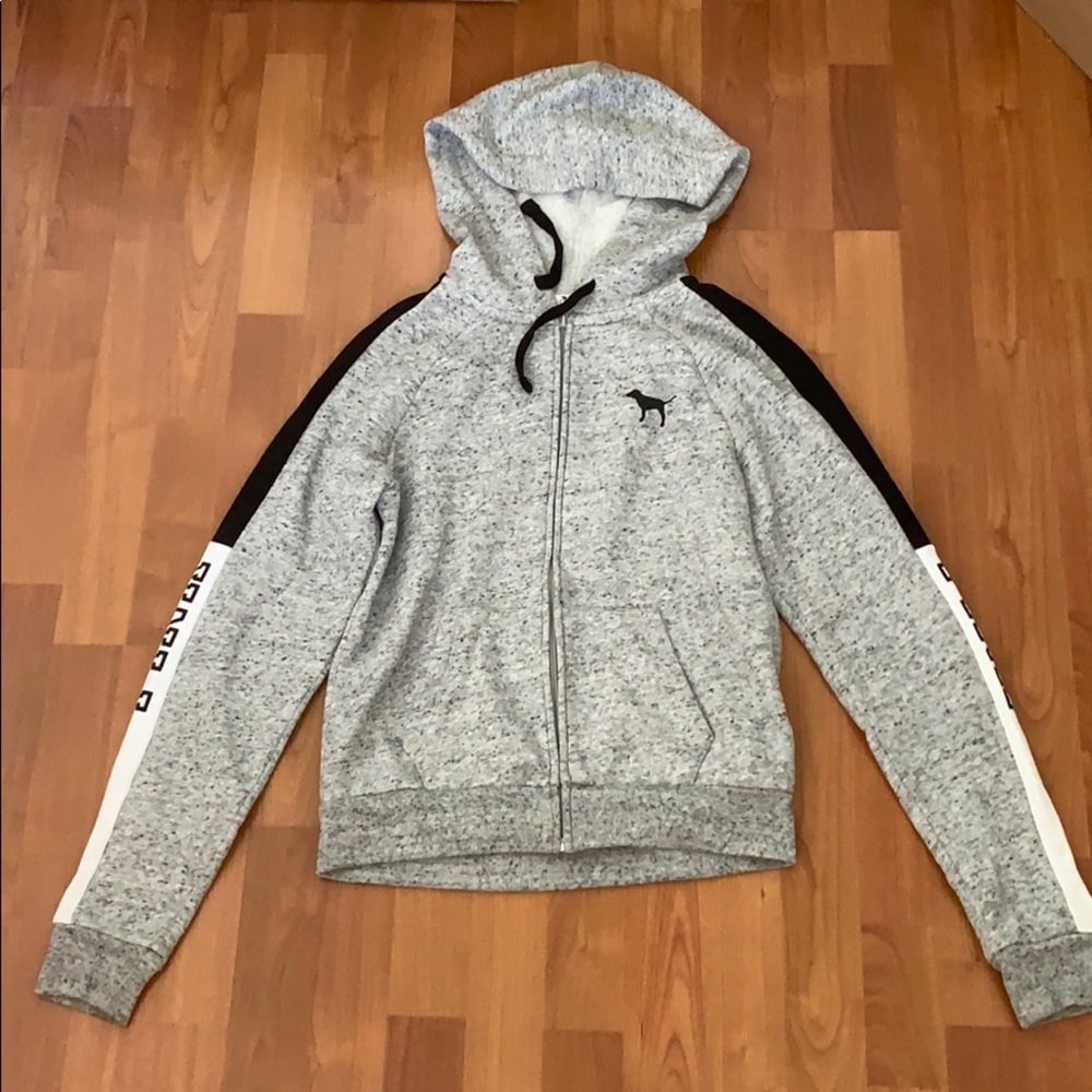 A grey, white, and black zip up sweater
